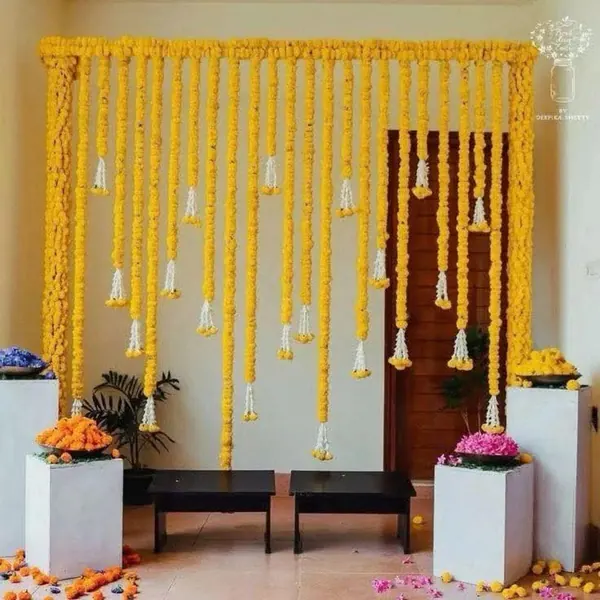 Yellow hanging floral strands above a simple home seating area
